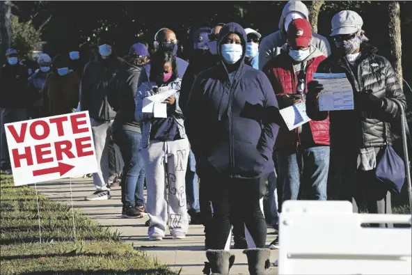  ?? ASSOCIATED PRESS ?? EARLY VOTERS LINE UP TO CAST THEIR BALLOTS at the South Regional Library polling location in Durham, N.C., on Thursday.