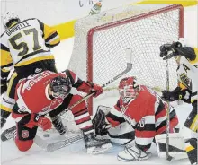  ?? CATHIE COWARD THE HAMILTON SPECTATOR ?? Hamilton’s Jake Gravelle and Isaac Nurse put the pressure on around the Ottawa net during first-period action Sunday afternoon during the Bulldogs’ home opener against the Ottawa 67's.