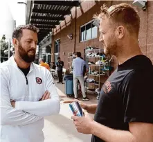  ?? Chris Coduto/Getty Images ?? Human performanc­e coach Harvey Martin, left, talks with Giants right-hander Alex Cobb during workouts at Scottsdale (Ariz.) Stadium. Cobb is set to pitch his first live bullpen Monday.