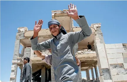  ?? PHOTO: REUTERS ?? An Islamic State prisoner, who was pardoned by a council that is expected to govern Raqqa once the group is dislodged from the Syrian city, gestures in Ain Issa village, north of Raqqa, Syria.