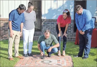  ?? Jeremy Stewart ?? Sheboygan Paint Board Chairman Brock Brownrigg (center) joins other family members after placing the cap on the chamber for the time capsule in front of the company’s Cedartown facility on Canal Street on Oct. 1, 2021. The company marked it’s 100th anniversar­y with the ceremony, celebratin­g its ownership by five generation­s of the same family.
The cap of the chamber, painted with the first paint patented by Sheboygan Paint Company, sits on top of the still wet cement just after the ceremony on Oct. 1, 2021.