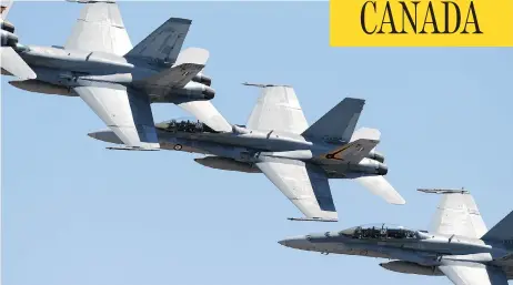  ?? CARLA GOTTGENS / BLOOMBERG ?? Defence Minister Harjit Sajjan announced in November the government’s decision to begin negotiatio­ns to buy 18 Boeing Super Hornets, like the ones pictured, as “interim” fighter jets until a permanent fleet to replace the existing CF-18 aircraft could...