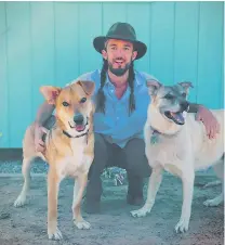  ?? COURTESY PHOTO ?? Zach Hively shows off his dogs, Rhyzik and Hawkeye. He recently adopted Rhyzik from Española Humane.