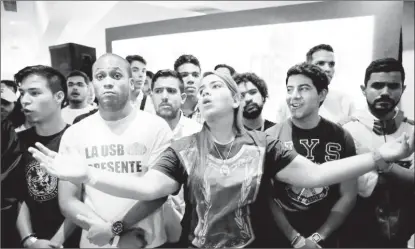  ??  ?? Opposition supporters react while listening to the results of the nationwide election for new governors, at the campaign headquarte­rs of the Venezuelan coalition of opposition parties (MUD) in Caracas, Venezuela October 15, 2017.