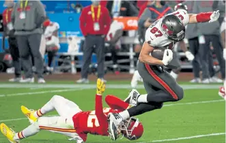  ?? Patrick Smith, Getty Images ?? The Bucs’ Rob Gronkowski runs over the Chiefs’ Tyrann Mathieu during the second quarter of the Super Bowl on Sunday in Tampa, Fla.