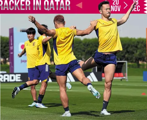  ?? — AP ?? Sweating it out: Japan players warm up during a training session ahead of their Group e match against Costa rica in doha.