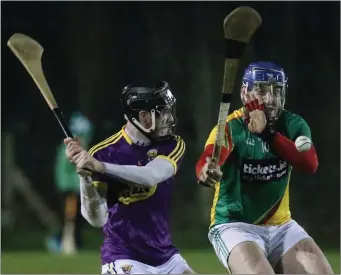  ??  ?? Wexford midfielder Joe O’Connor about to strike the ball as Carlow’s Seamus Murphy moves in. Murphy was sent-off for an incident in the immediate aftermath.