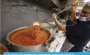  ?? ?? A cook carefully scoops vegetables from a simmering pot. - Photos by Yasser Al-Zayyat