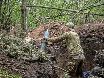  ?? ?? GAINS: A Ukrainian soldier firing a 120mm mortar at a Russian target, near Bakhmut.