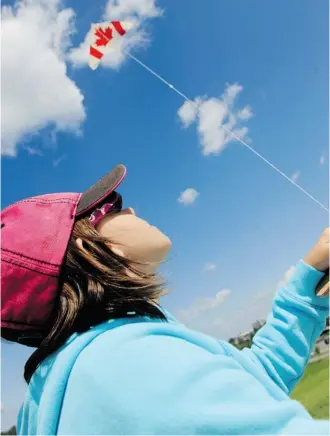  ?? BRUCE DEACHMAN/OTTAWA CITIZEN ?? Gillian Lister, 9, flies her Canadian flag kite in the skies high above Ottawa.