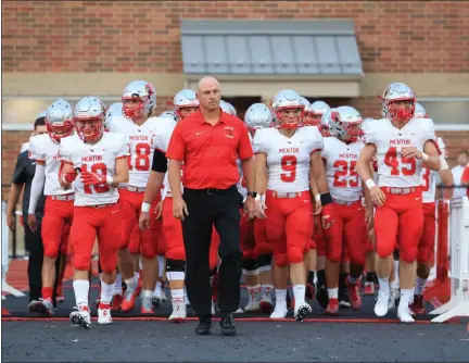  ?? TIM PHILLIS — FOR THE NEWS-HERALD ?? Mentor coach Steve Trivisonno led the Cardinals onto the field for 23years as head coach before stepping down after the 2019season.