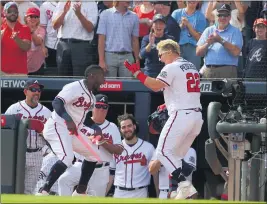  ?? KEVIN C. COX — GETTY IMAGES ?? The Braves’ Joc Pederson, right, celebrates with Guillermo Heredia after hitting a threerun home run in the fifth inning of Game 3of the NLDS against the Milwaukee Brewers.