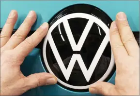  ?? JENS MEYER — THE ASSOCIATED PRESS FILE ?? A worker completes an electric car ID.3 body at a Volkswagen plant in Zwickau, Germany.