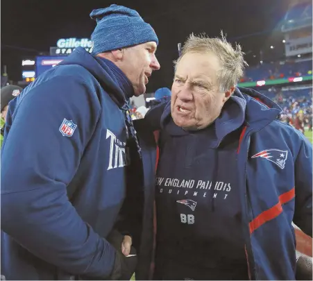  ?? STAFF PHOTO BY MATT WEST ?? THANKS FOR COMING: Patriots coach Bill Belichick hugs Titans counterpar­t Mike Mularkey after last night’s divisional round playoff game at Gillette Stadium. The Patriots cruised to a 35-14 victory.