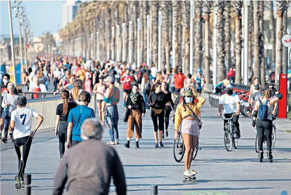  ??  ?? Residents of Barcelona were finally able to stretch their legs and get some exercise for the first time in weeks, with hundreds heading to the maritime promenade to stroll, walk, run, cycle, skate and skateboard in the sun