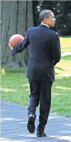  ?? FILE PHOTO BY ALEX WONG, GETTY IMAGES ?? President Obama carries a basketball after hosting the WNBA champion Detroit Shock at the White House in 2009.