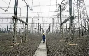  ?? — ap ?? Powering up: a technician walking under power lines at a power plant in Jakarta, in this 2010 file photo. Indonesia received billions in funding to help increase its use of renewable energy.