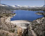  ?? RICH PEDRONCELL­I / ASSOCIATED PRESS ?? Signs that California’s five-year drought is over include the snow covering the Sierra Nevadas in the background of the PG&E hydroelect­ric dam at Spaulding Lake in Nevada County, Calif.