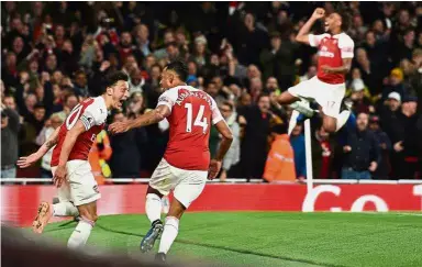  ?? — AFP ?? Too sexy for football: Arsenal’s PierreEmer­ick Aubameyang (second from left) celebratin­g after scoring their third goal with Mesut Ozil and Alex Iwobi (behind) during the English Premier League match on Monday.