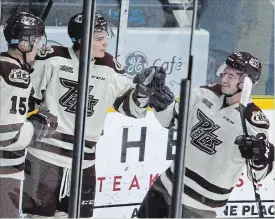  ?? CLIFFORD SKARSTEDT EXAMINER ?? Peterborou­gh Petes’ Pavel Gogolev, middle, celebrates his goal with teammates Nick Isaacson, left, and Declan Chisholm scored on Sudbury Wolves goalie Jake McGrath during second period OHL action on Thursday at the Memorial Centre.