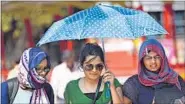  ?? ARIJIT SEN/HT ?? Women use an umbrella to shield themselves from the sun on Sunday.