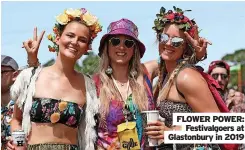  ?? ?? FLOWER POWER: Festivalgo­ers at Glastonbur­y in 2019