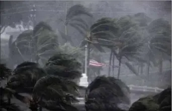  ?? DAVID GOLDMAN — THE ASSOCIATED PRESS ?? An American flag is torn as Hurricane Irma passes through Naples, Fla., Sunday.