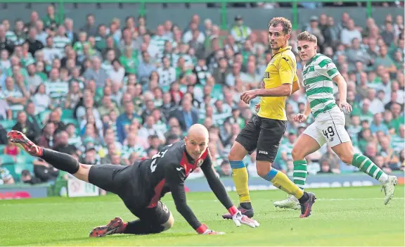  ?? Picture: Getty Images. ?? James Forrest beats Alashkert keeper Ognjen Cancarevic to make it 3-0 to Celtic.