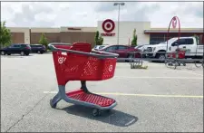  ?? BILL SIKES — THE ASSOCIATED PRESS FILE ?? In this file photo a shopping cart sits in the parking lot of a Target store in Marlboroug­h, Mass. Target Corp. reports financial results Wednesday, Aug. 21.