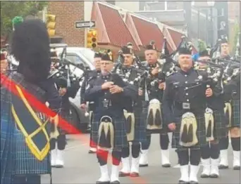  ?? BILL RETTEW JR. – DIGITAL FIRST MEDIA ?? Chester County Emerald Society Drum and Pipe Band salutes fallen heroes in West Chester, at the Chester County Law Enforcemen­t Memorial Service.