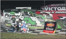  ?? RICH KEPNER - FOR MEDIANEWS GROUP ?? Brian Hirthler poses with the checkered flag after his win Saturday night at Grandview Speedway.