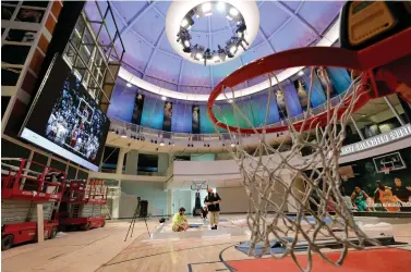  ?? Steven Senne/Associated Press ?? ■ Workers perform restoratio­ns Tuesday at the Naismith Memorial Basketball Hall of Fame in Springfiel­d, Mass. The museum is scheduled to reopen this month with a whole new look after a $22 million renovation.