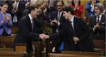  ?? ADRIAN WYLD/THE CANADIAN PRESS ?? Finance Minister Bill Morneau, left, projects a $19.9-billion deficit for 2017-18, $8.6 billion less than was expected.