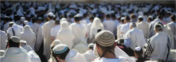  ?? (Photo by Ariel Schalit, AP) ?? In this May 24, 2017 file photo, Jewish men pray at the Western Wall, the holiest place where Jews can pray, in Jerusalem's Old City. Israel's rabbinical authoritie­s have compiled a list of overseas rabbis whose authority they refuse to recognize when...