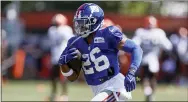  ?? RON SCHWANE — THE ASSOCIATED PRESS FILE ?? Giants running back Saquon Barkley (26) runs through a drill during a joint practice with the Browns last month in Berea, Ohio.
