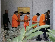  ?? —Bernama photo ?? Several of the suspects are escorted by MACC officers at the court for the remand applicatio­n.