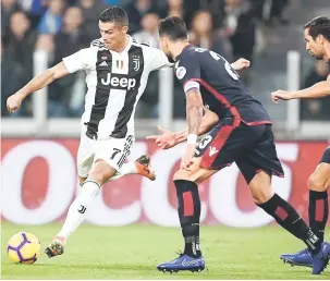  ?? — Gambar AFP ?? CETUS INSPIRASI: Ronaldo (kiri) melepaskan rembatan yang cuba di halang oleh pemain Cagliari ketika beraksi pada perlawanan di Stadium Allianz, Turin pada Sabtu lepas.