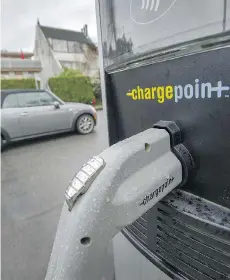  ?? ARLEN REDEKOP ?? An electric vehicle charging station in Vancouver. The technology has fuelled uncertaint­y over the future of transporta­tion.