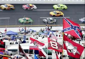  ?? Rob Carr/Associated Press ?? A Confederat­e flag flies in the infield as cars come out of the first turn during a 2007 NASCAR auto race at Talladega Superspeed­way in Talladega, Ala.