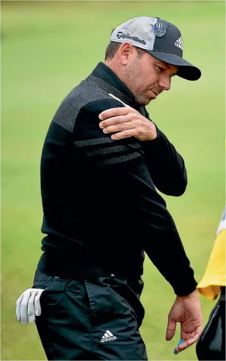  ??  ?? Sergio Garcia feels his shoulder after swatting his wedge into the gorse during the second round of the British Open at Royal Birkdale yesterday.