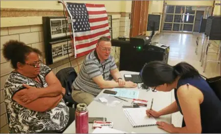  ?? KEITH WHITCOMB -- KWHITCOMB@DIGITALFIR­STMEDIA.COM ?? Election inspectors Brenda Harrison, and Gary Pavlic greet Erika Groff, of 2nd Street in Troy, at the School 12polling location on Tuesday.