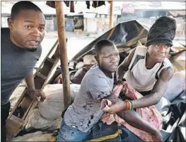  ?? Marco Longari AFP/Getty Images ?? A WOUNDED man is helped to safety as a protest turns violent in Harare.