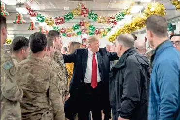  ?? (AP Photo/Andrew Harnik) ?? President Donald Trump visits with members of the military at a dining hall at Al Asad Air Base, Iraq, Wednesday, Dec. 26, 2018.