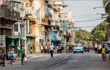  ?? MERIDITH KOHUT/THE NEW YORK TIMES ?? A street in Havana, Cuba, a country only recently opened to US travellers. With Donald Trump set to become the 45th president of the United States, the spirit of openness that has permeated everything from our increasing­ly global economy to how we...