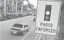  ?? JIM RASSOL/STAFF FILE PHOTO ?? After a warning period, Boynton Beach started fining red-light runners on Sept. 15. Since then, nearly 2,000 drivers have been fined.