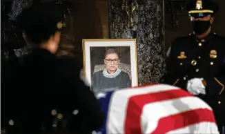  ?? ERIN SCHAFF / NEW YORK TIMES ?? ▲The flag-draped casket of Justice Ruth Bader Ginsburg lies in state in the U.S. Capitol on Friday in Washington, D.C. Ginsburg is the first woman to lie in state at the Capitol.