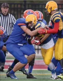  ?? CATHIE COWARD, THE HAMILTON SPECTATOR ?? A Saltfleet ball carrier is shut down by MacNab’s powerful defence during the HWDSB senior boys’ football championsh­ip Wednesday afternoon. MacNab won the contest, 40-17.