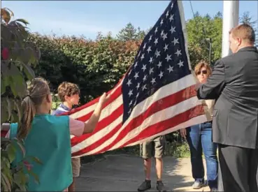  ?? GINGER RAE DUNBAR – DIGITAL FIRST MEDIA ?? Bradford Heights Elementary School Cub Scouts and Girl Scouts lead their classmates during the third annual Bradford Heights Patriots’ Flag Raising ceremony held at the school in West Bradford on Monday. Bradford Heights Principal Andrew Hoffert, far...