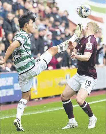  ?? ?? Yang Hyun-jun fouls Hearts’ Alex Cochrane with a high foot which led to a red card following a VAR check