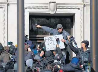  ?? STACEY WESCOTT/CHICAGO TRIBUNE ?? Brandon Lesco, of California, celebrates the acquittal of Kyle Rittenhous­e outside the Kenosha County Courthouse on Friday in Kenosha.